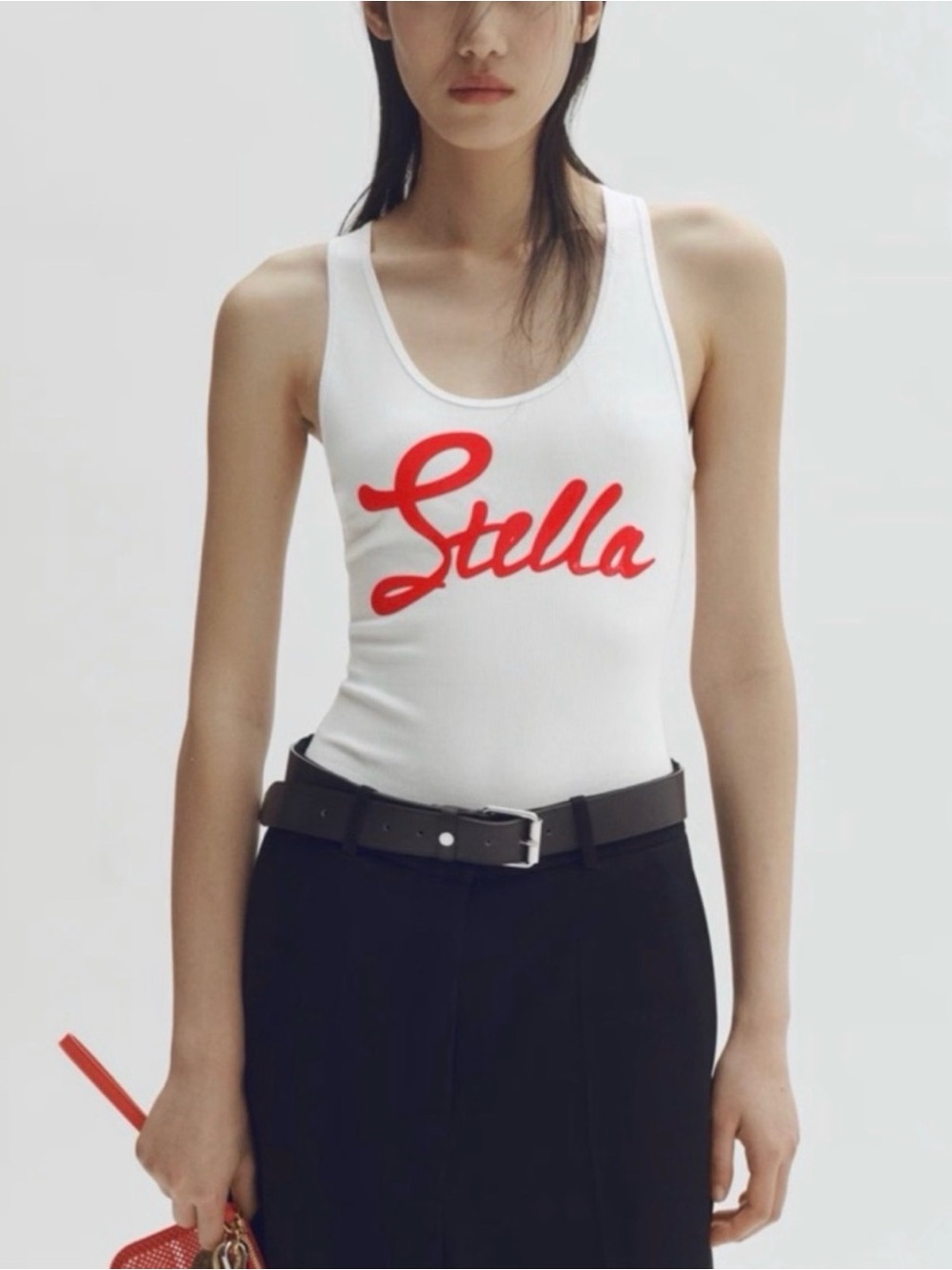 H&M x Stella McCartney 
White bodysuit with Red Script Logo